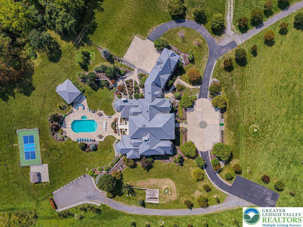5044 Vera Cruz Road Center Valley, PA 18034 - Photo 9 of 100 an aerial view of a house with a garden and swimming pool