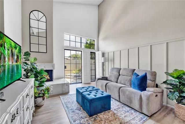 a living room with furniture and a potted plant