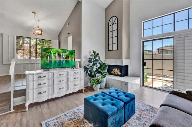 a living room with furniture fireplace and window