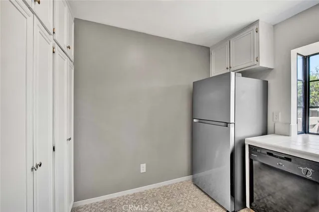 a view of a kitchen with a refrigerator and electronic appliances