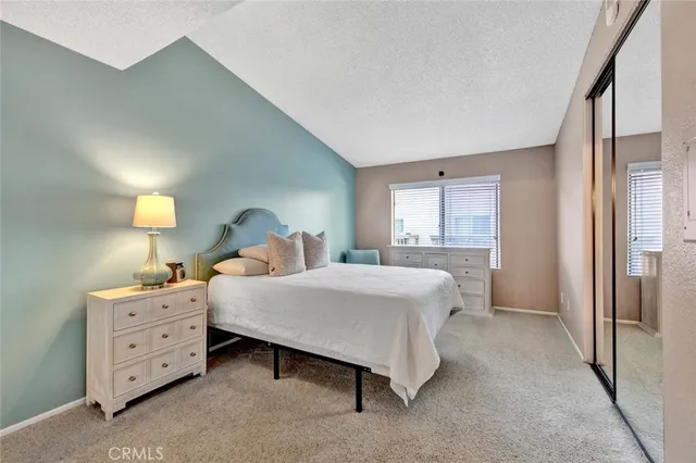 a bed room with a bed and a window