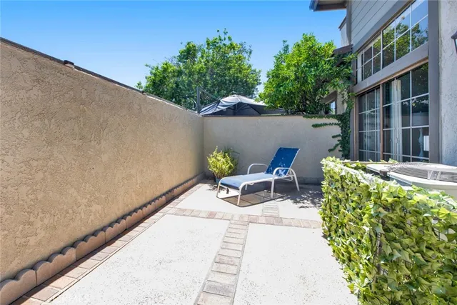 a front view of a house with outdoor seating and plants