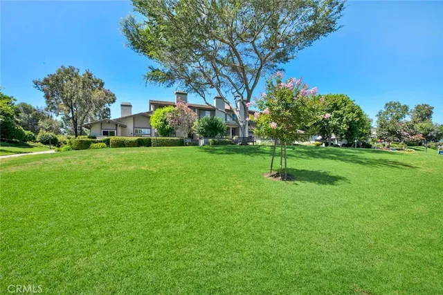 a view of a house with pool and chairs