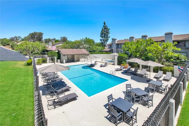 a view of a house with pool and chairs