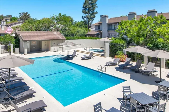 a view of a house with pool and chairs