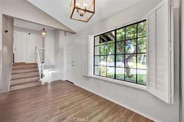 a view of an entryway with wooden floor and door