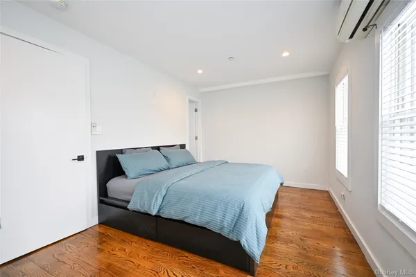 a bedroom with a bed and a night stand