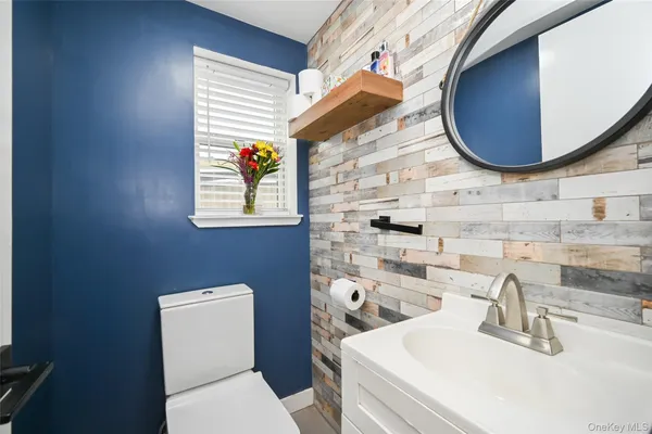 a bathroom with a sink a toilet and shower curtain