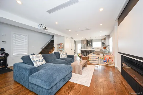 a living room with furniture a fireplace and a large window