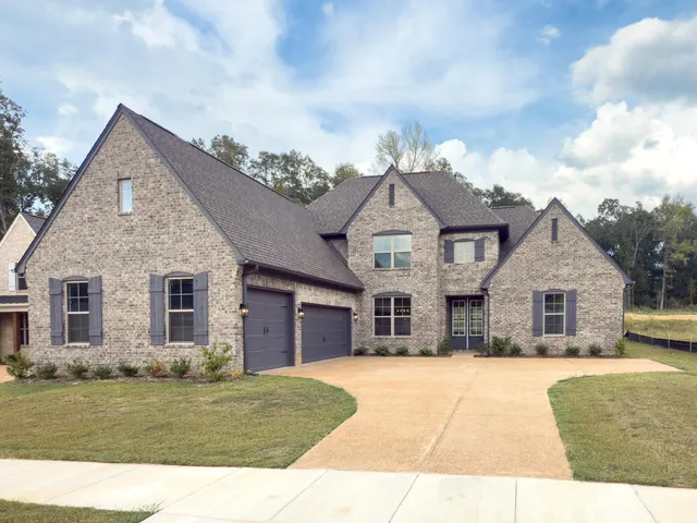 a view of an empty room with a kitchen and fireplace