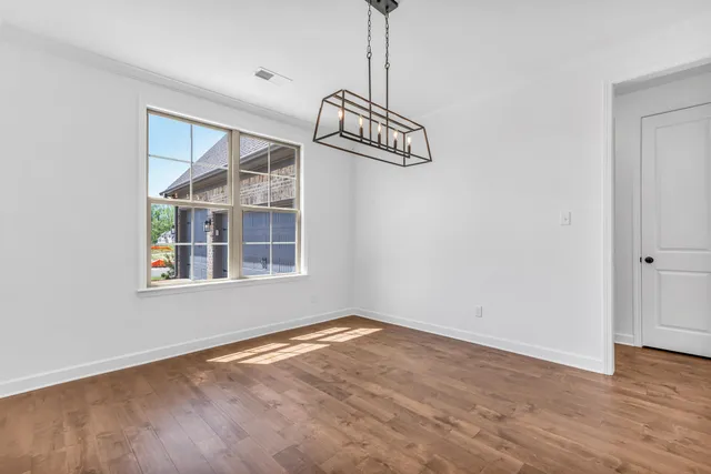 a view of empty room with fireplace and windows