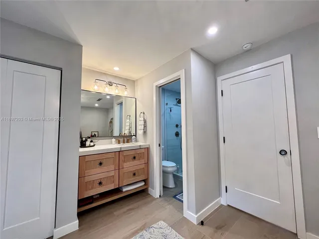 a room with a dresser and mirror