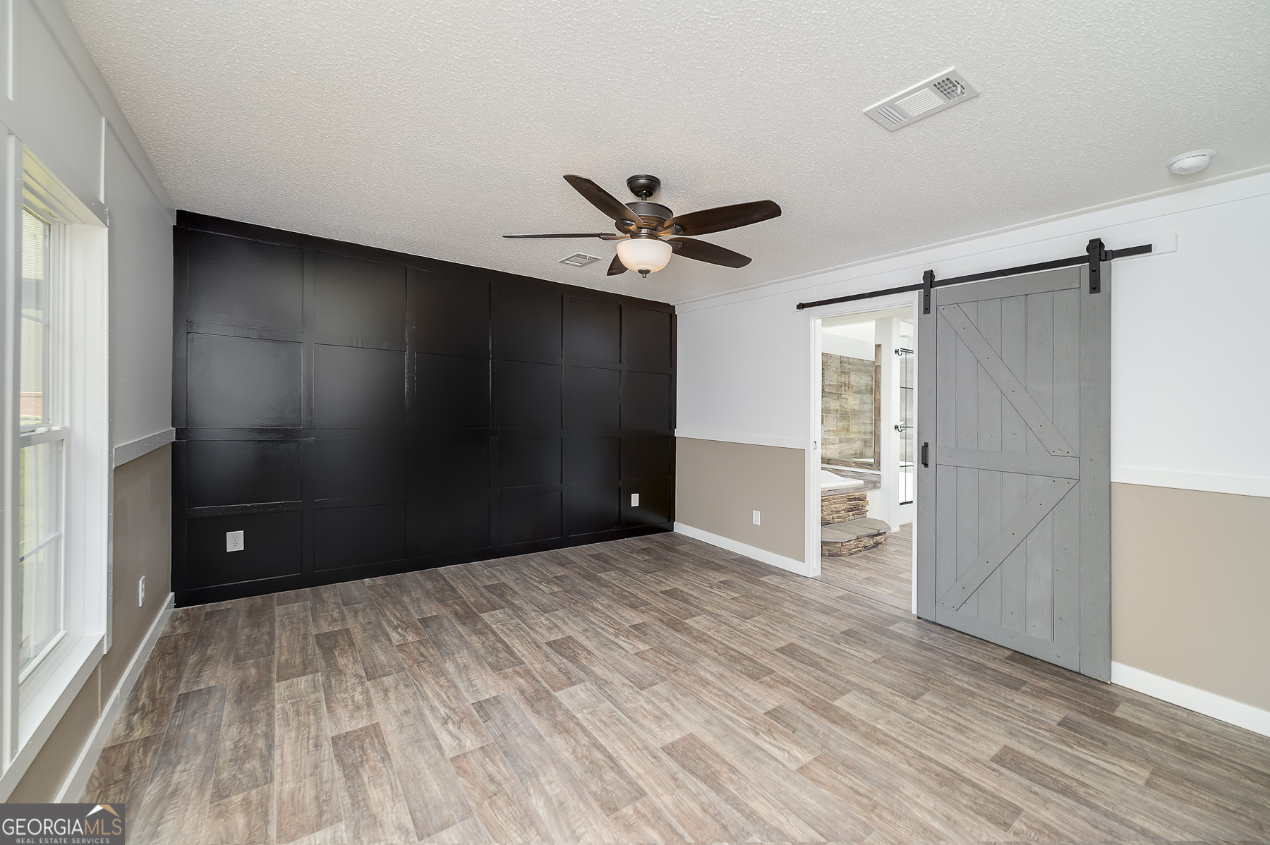 595 Barnetts Bridge Road Jackson, GA 30233 - Photo 28 of 47 a view of a livingroom with a ceiling fan and wooden floor