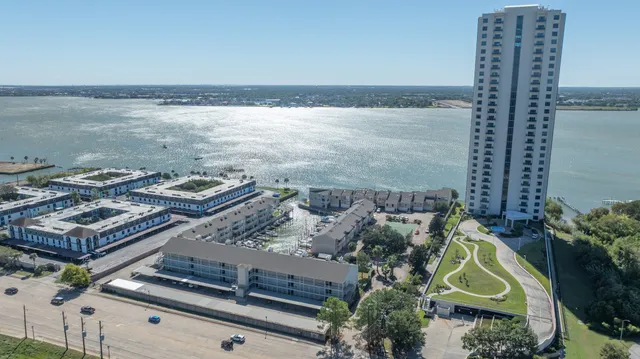 a kitchen with stainless steel appliances kitchen island granite countertop a sink a stove and white cabinets