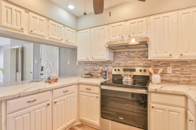 a view of a swimming pool with a patio and a yard