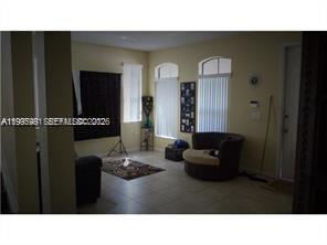 11235 Southwest 236 Lane Homestead, FL 33032 - Photo 3 of 3 a black and white photo of a living room