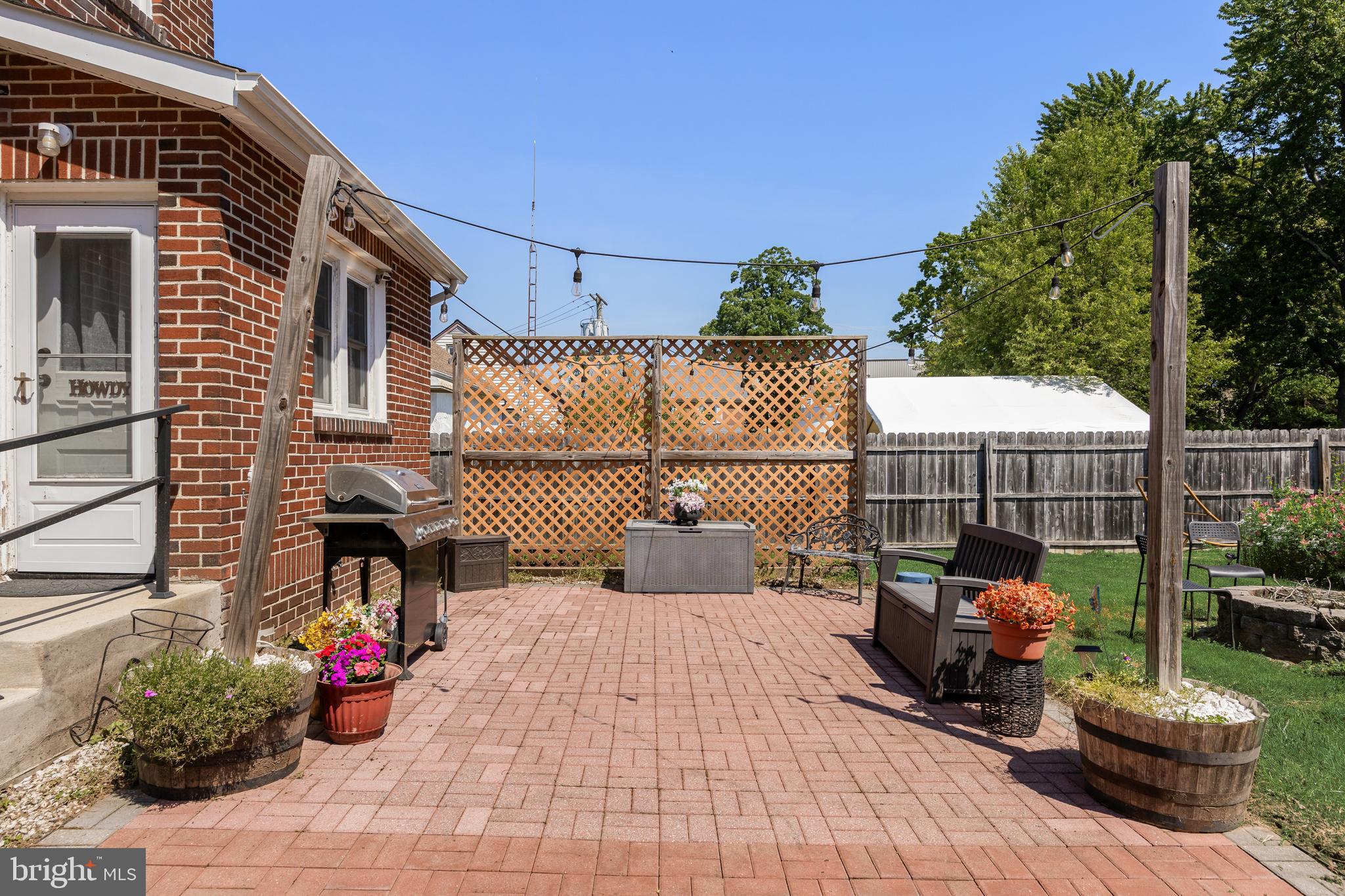 615 North Walnut Avenue Magnolia, NJ 08049 - Photo 28 of 40 a view of a chairs and table in the back yard of the house