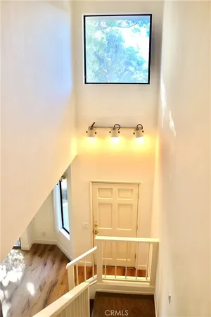 a view of a door and wooden floor