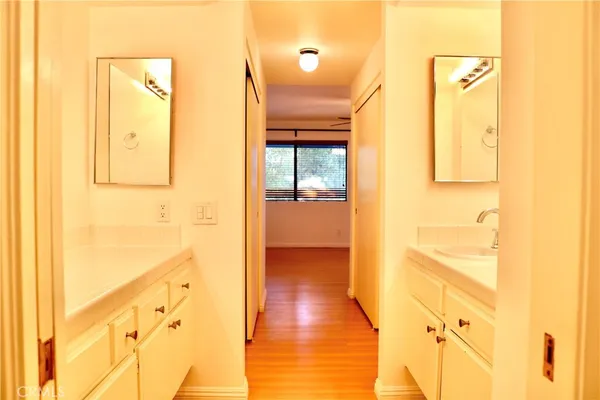 a view of a hallway with wooden floor