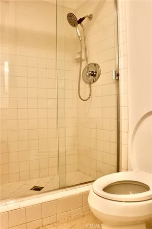 a bathroom with a toilet and a shower