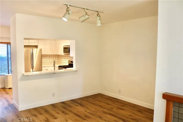 a view of a room with wooden floor and cabinet