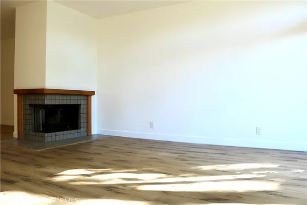 a view of an empty room with a fireplace