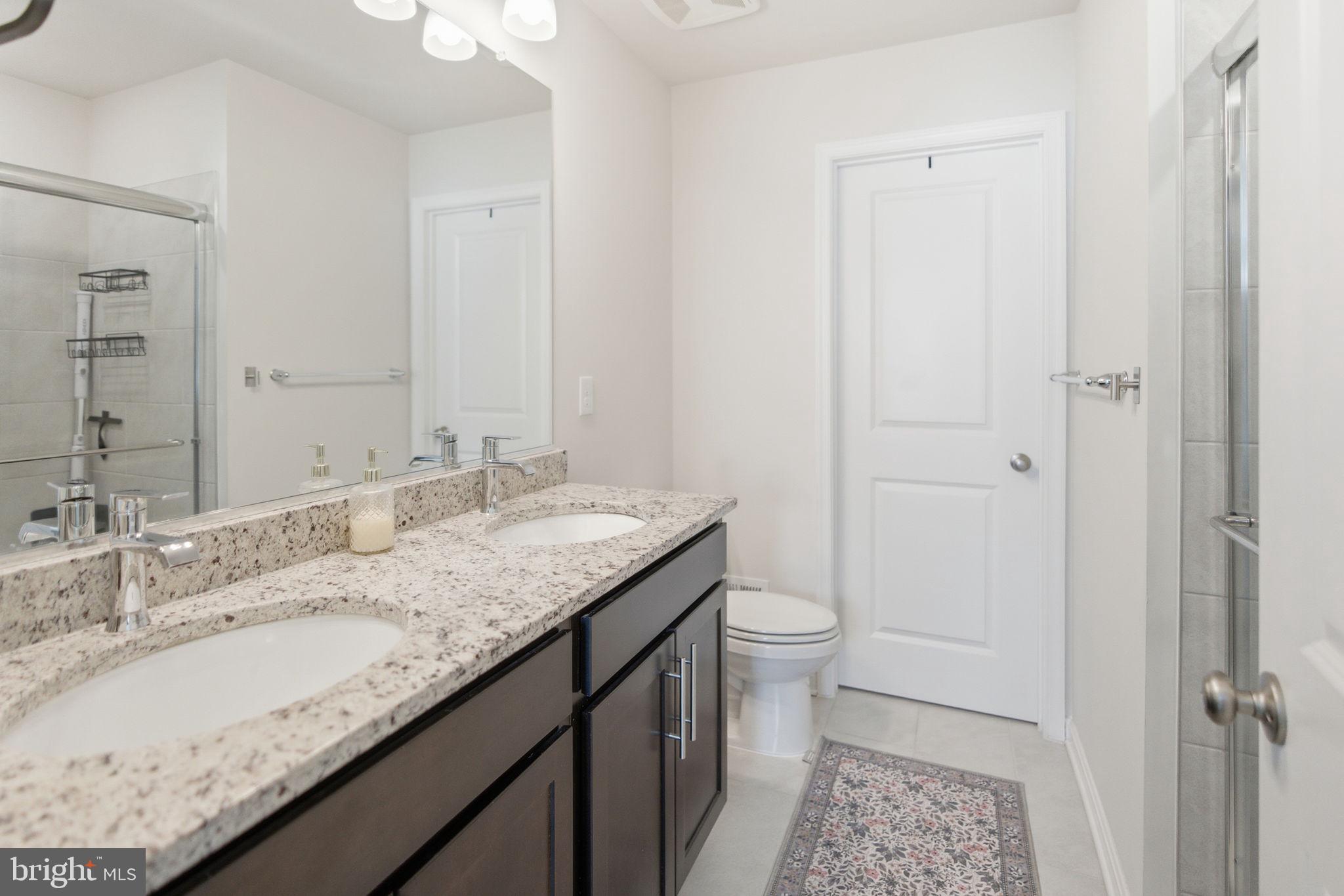 715 Courier Lane Frederick, MD 21701 - Photo 12 of 26 a bathroom with a granite countertop sink and a mirror