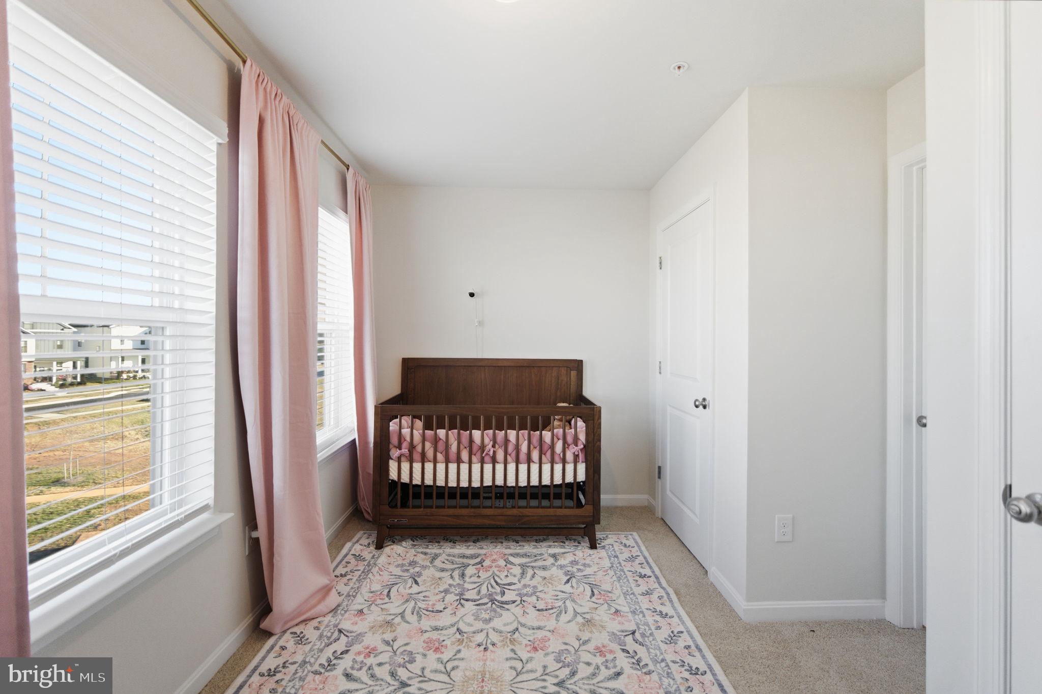 715 Courier Lane Frederick, MD 21701 - Photo 13 of 26 a bedroom with a bed and a window