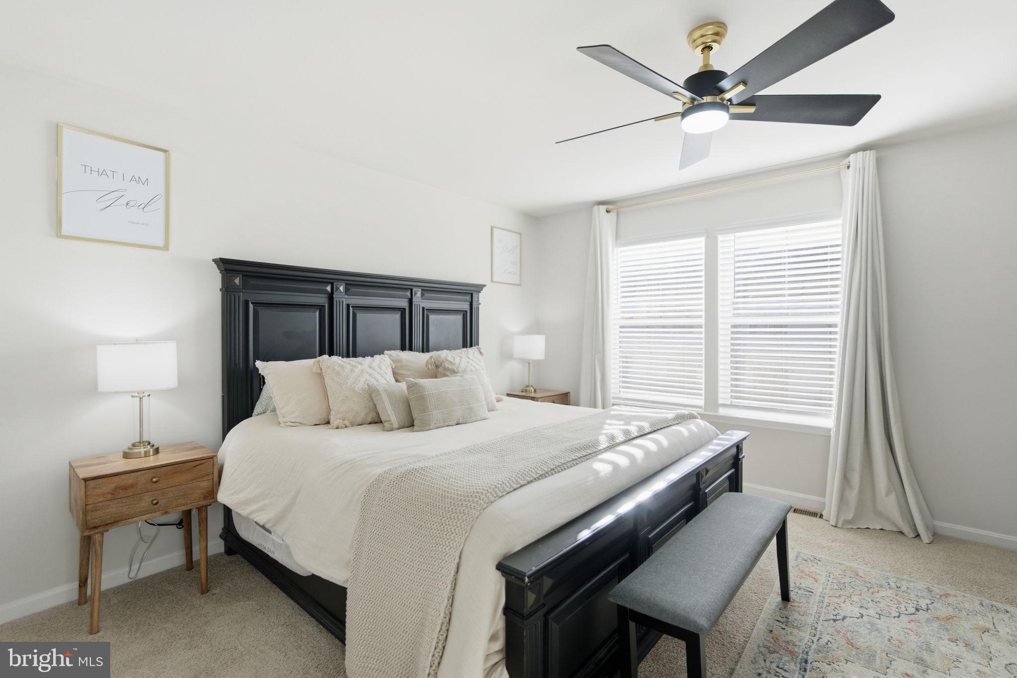 715 Courier Lane Frederick, MD 21701 - Photo 16 of 26 a bedroom with a bed a chandelier and a window