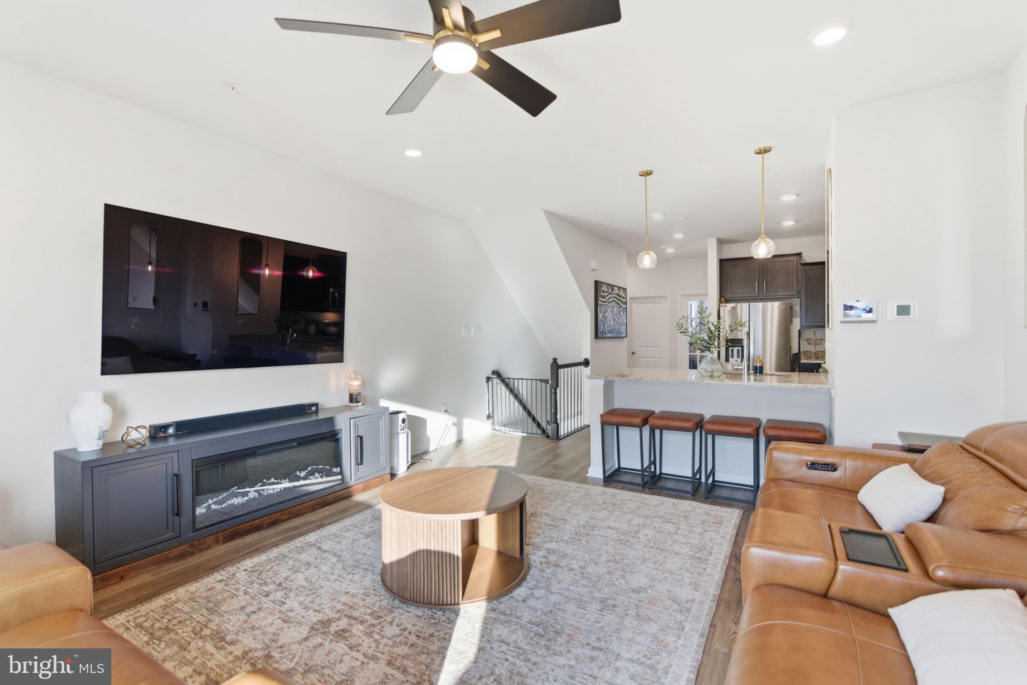 715 Courier Lane Frederick, MD 21701 - Photo 23 of 26 a living room with furniture and a flat screen tv