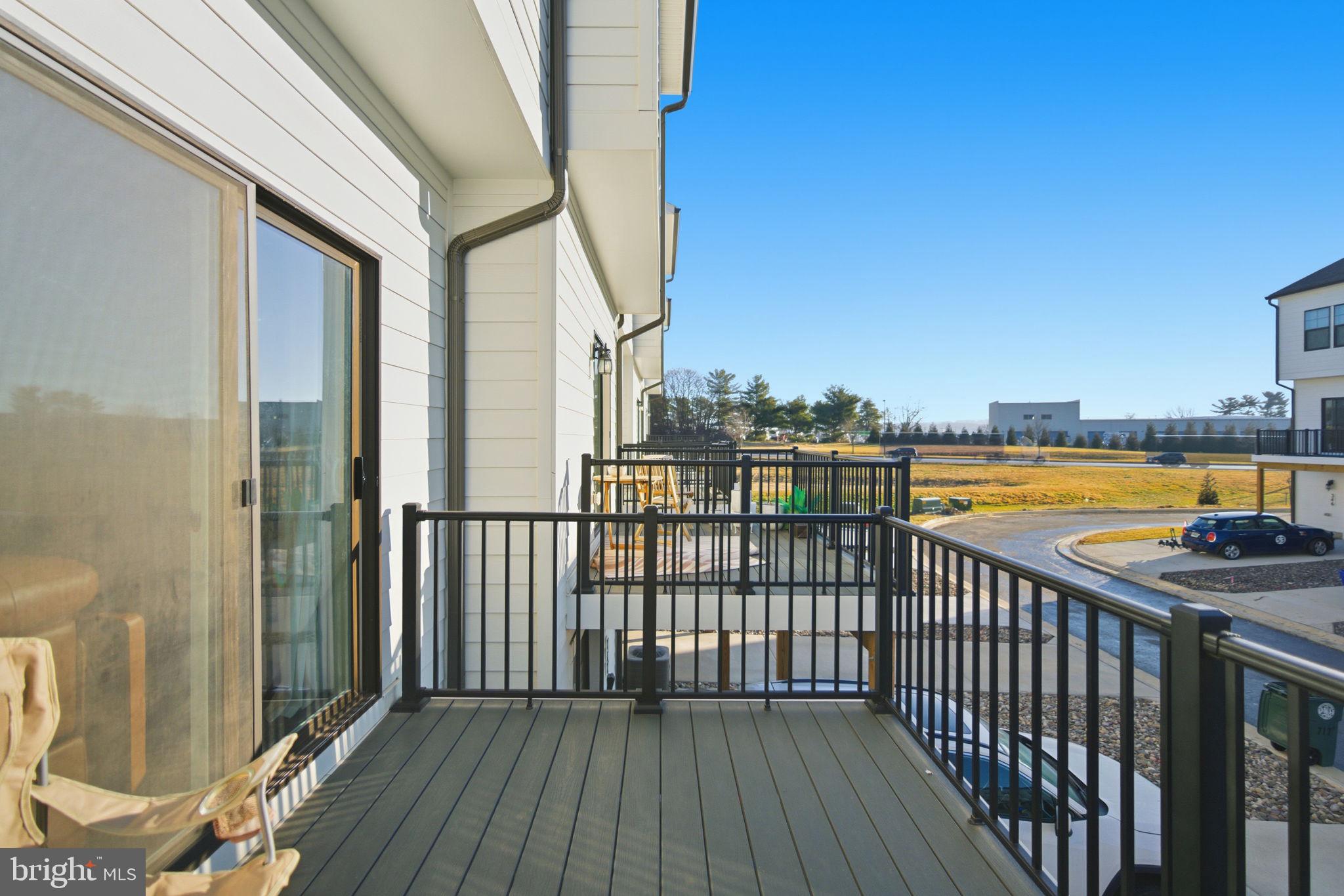 715 Courier Lane Frederick, MD 21701 - Photo 24 of 26 a view of a balcony with wooden floor & fence