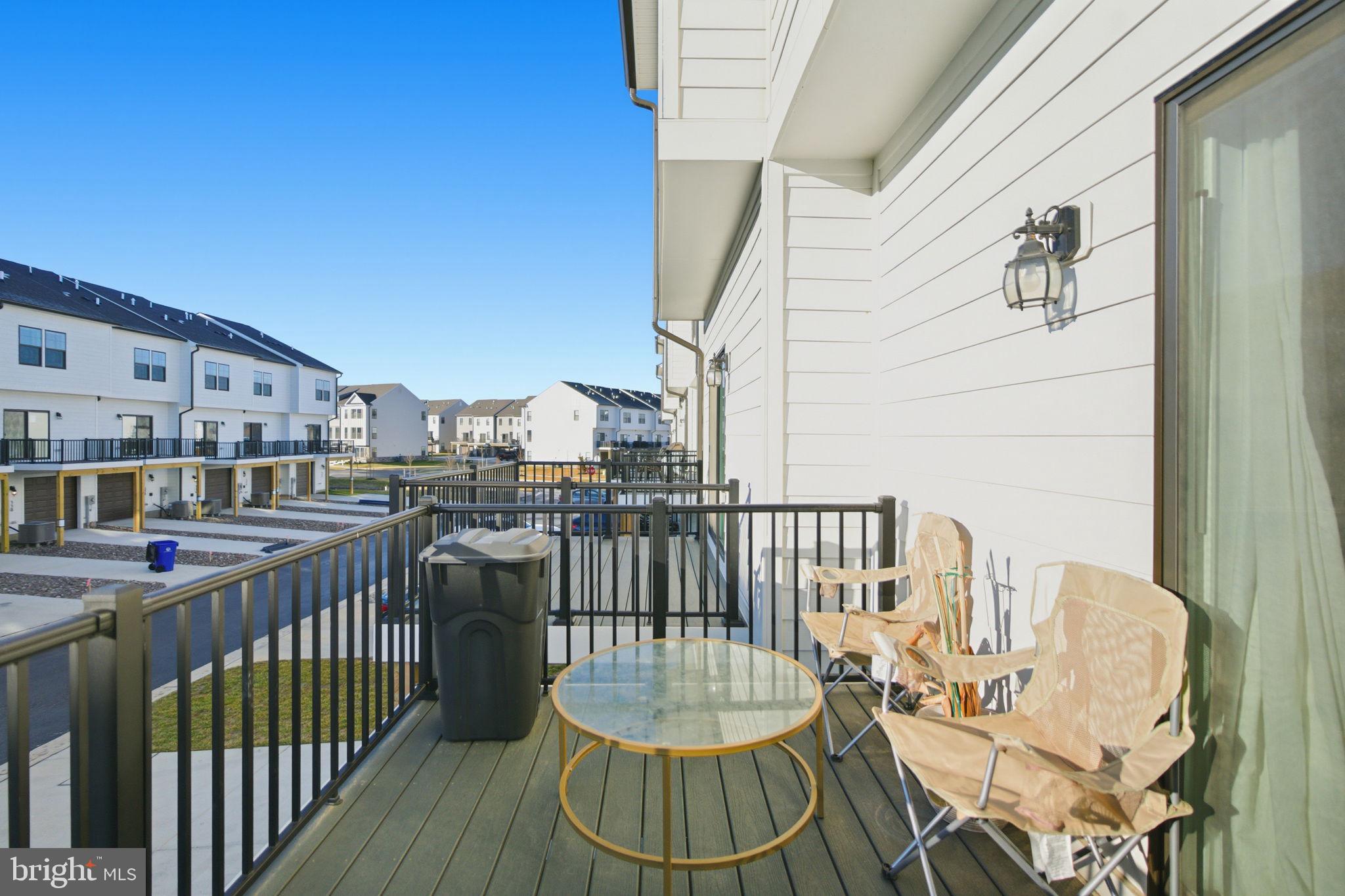 715 Courier Lane Frederick, MD 21701 - Photo 8 of 26 a view of a balcony with chair and iron fence