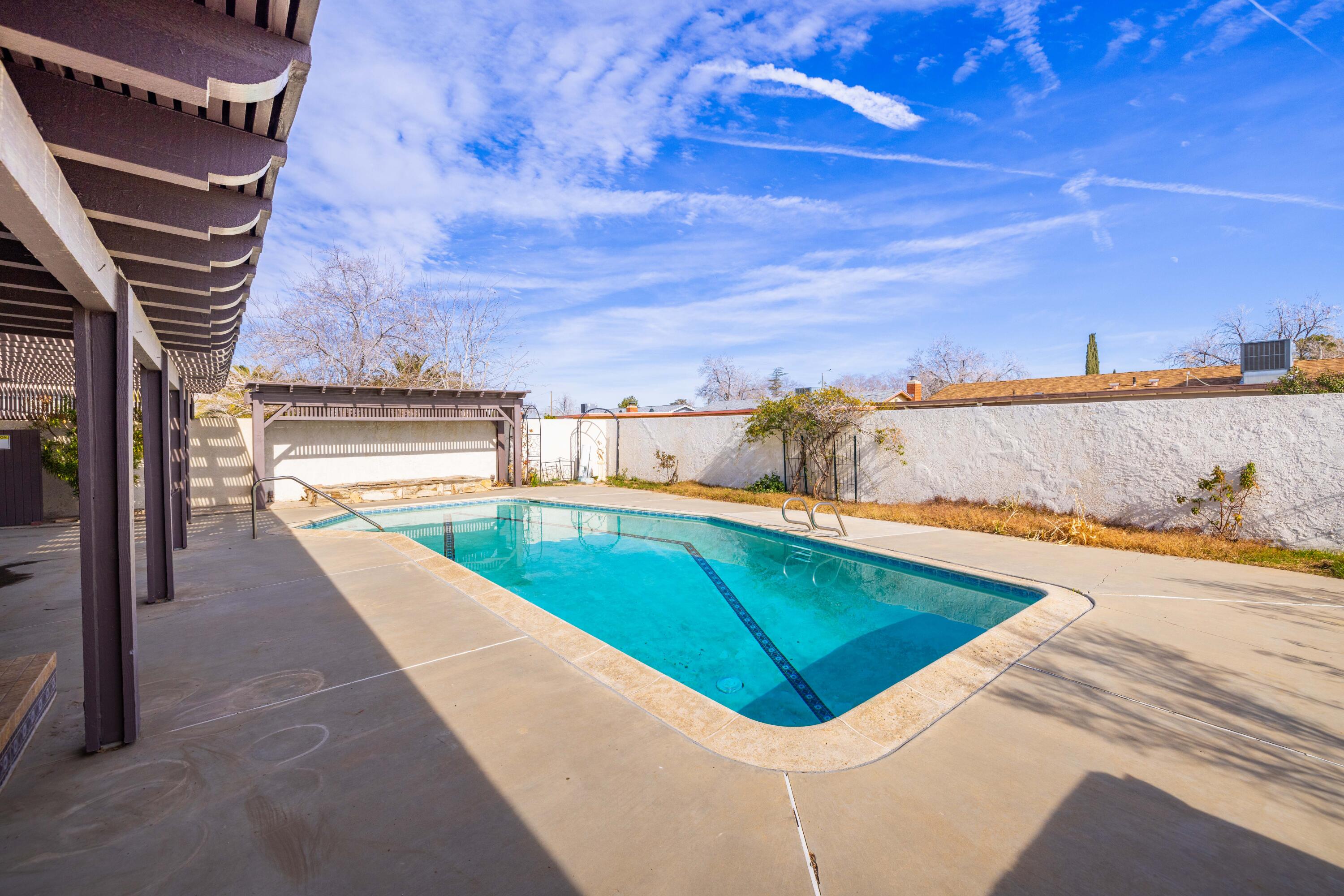 37800 Rudall Avenue Palmdale, CA 93550 - Photo 32 of 35 a view of a swimming pool with an outdoor seating