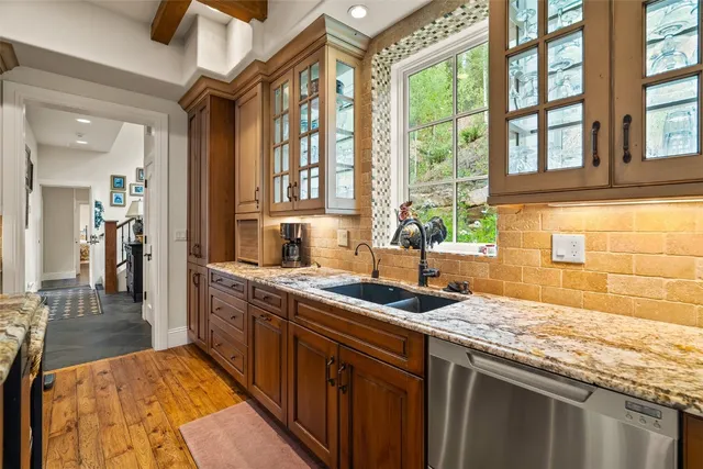 a kitchen with stainless steel appliances granite countertop a sink and a counter space