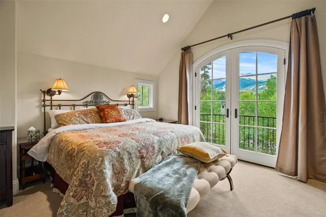 a bedroom with a bed and a large window