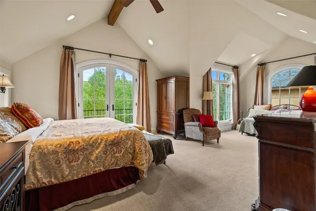 a bedroom with bed and glass windows