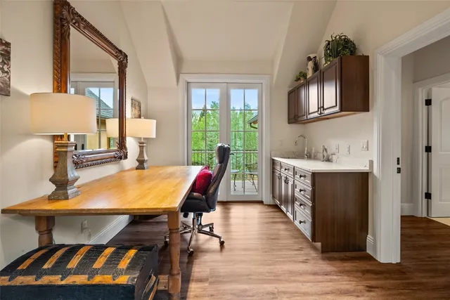 a bedroom with bed and wooden floor