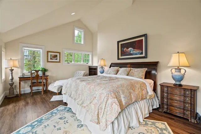 a bedroom with furniture and a large window