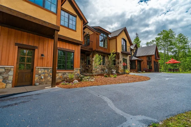 a view of a building with sitting area and garden