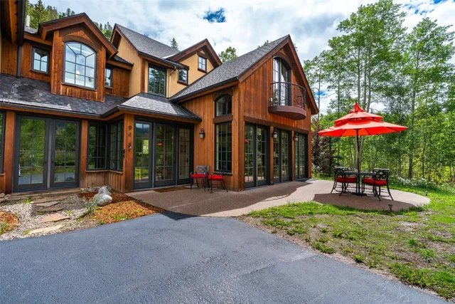 a patio with a table and chairs under an umbrella