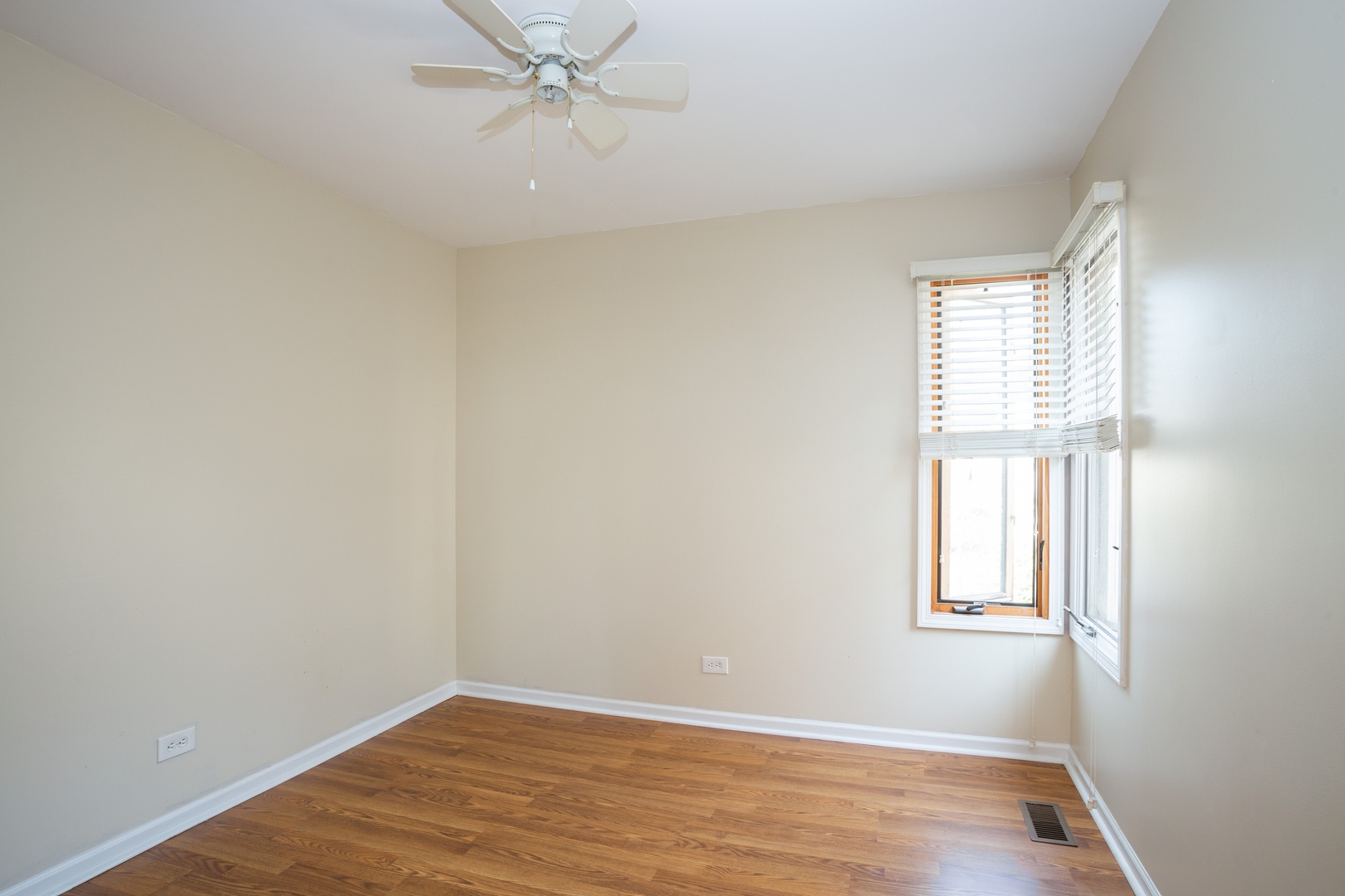 153 Inverness Court Elk Grove Village, IL 60007 - Photo 11 of 16 wooden floor in an empty room with a window