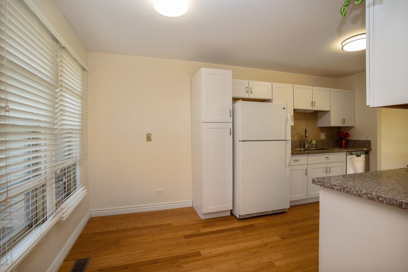 153 Inverness Court Elk Grove Village, IL 60007 - Photo 6 of 16 a white refrigerator freezer sitting in a kitchen
