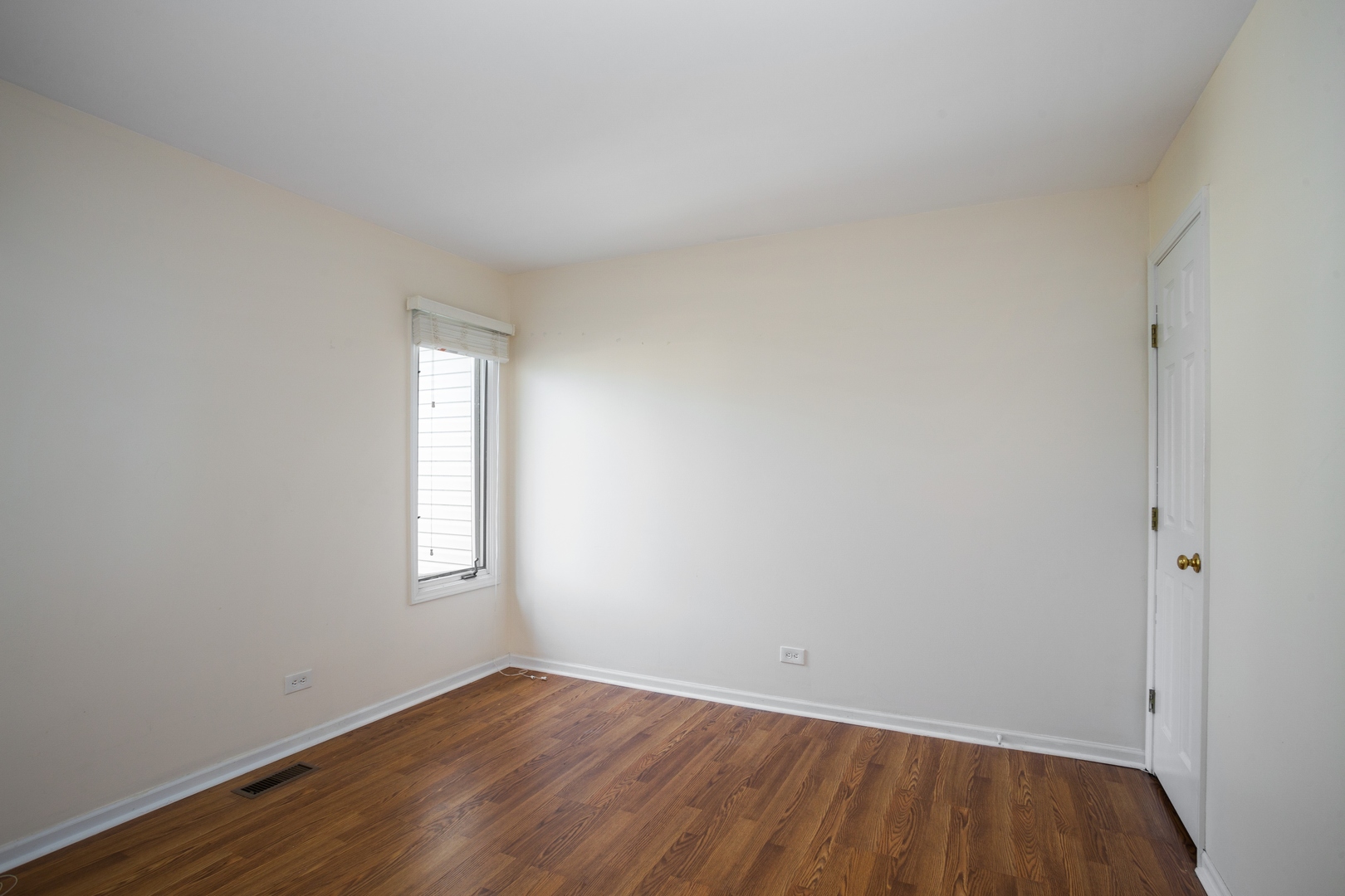 153 Inverness Court Elk Grove Village, IL 60007 - Photo 10 of 16 an empty room with wooden floor and windows