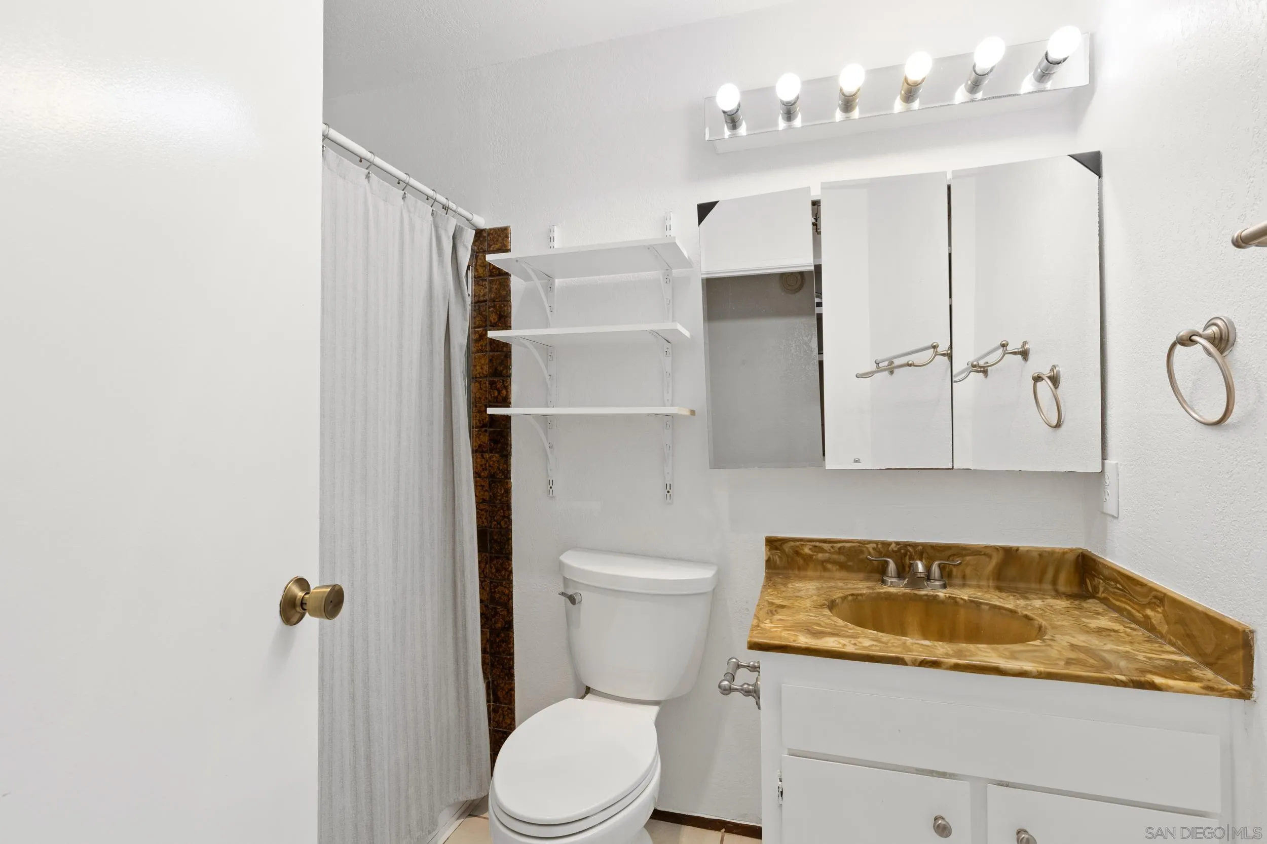 538 Paraiso Avenue Spring Valley, CA 91977 - Photo 12 of 17 a bathroom with a sink a toilet and shower