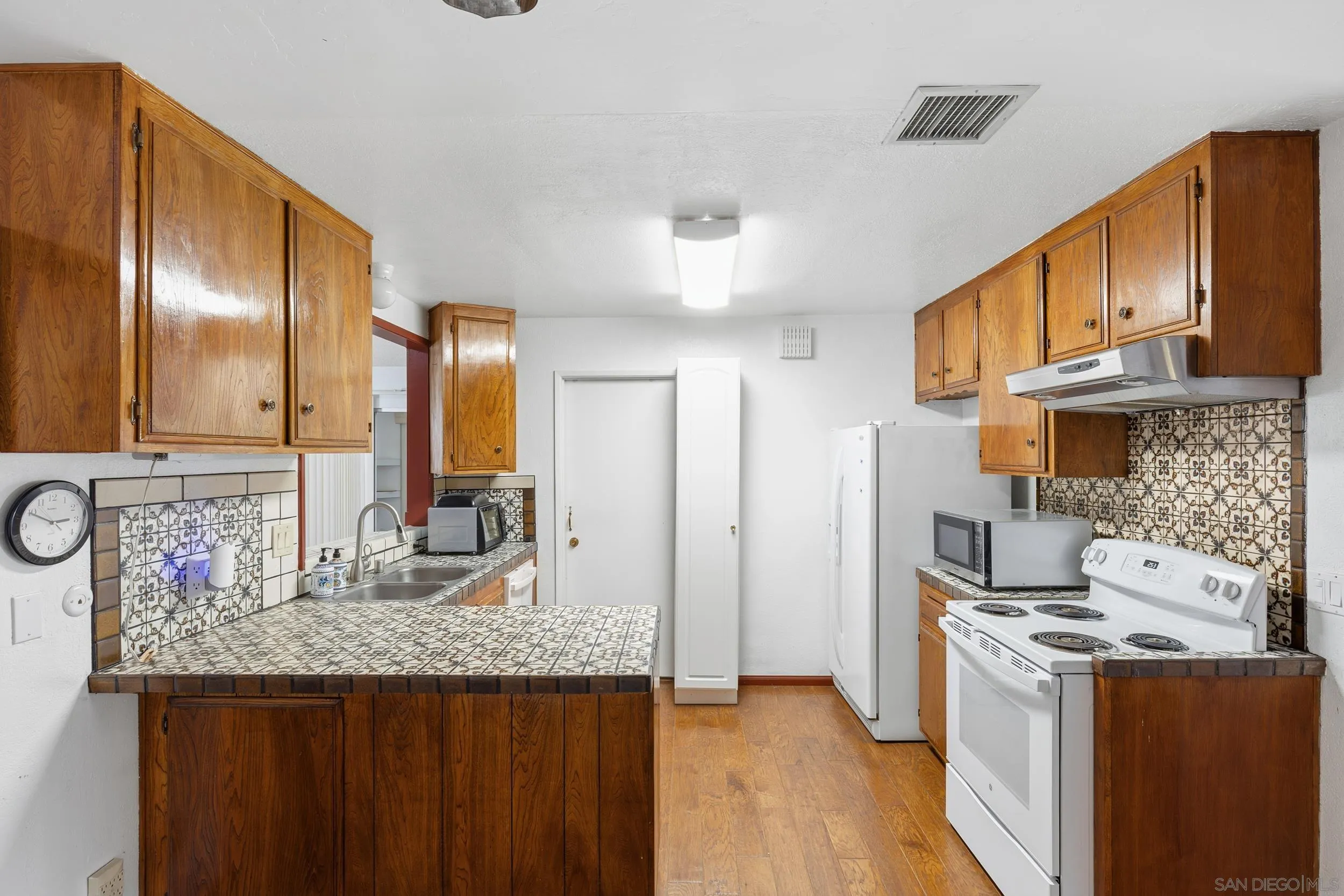 538 Paraiso Avenue Spring Valley, CA 91977 - Photo 2 of 17 a kitchen with stainless steel appliances granite countertop a sink stove and refrigerator