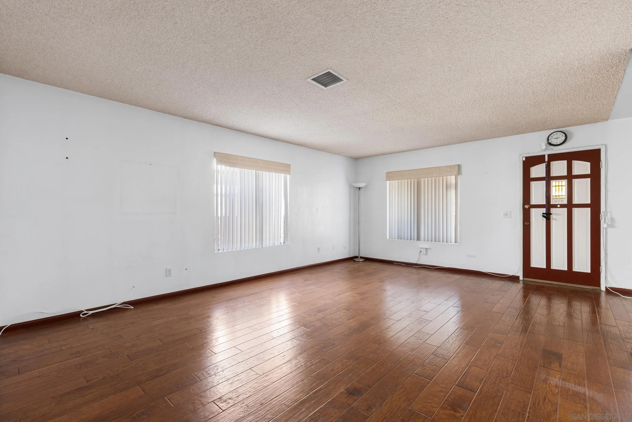 538 Paraiso Avenue Spring Valley, CA 91977 - Photo 7 of 17 a view of an empty room with window and wooden floor