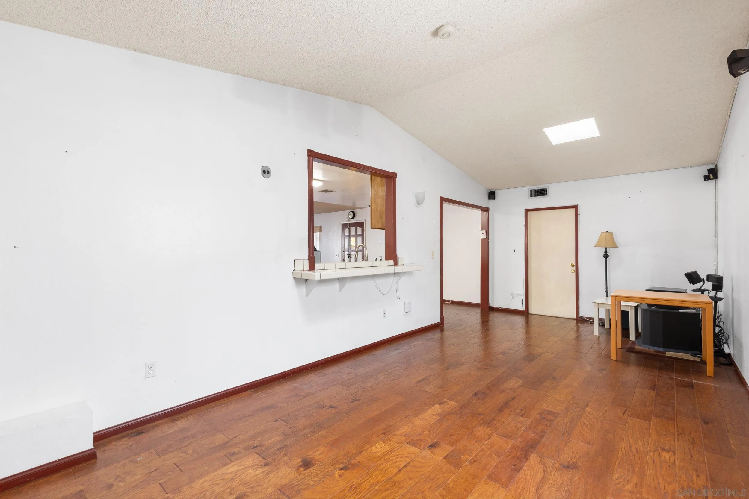 538 Paraiso Avenue Spring Valley, CA 91977 - Photo 9 of 17 a view of an empty room with furniture and wooden floor