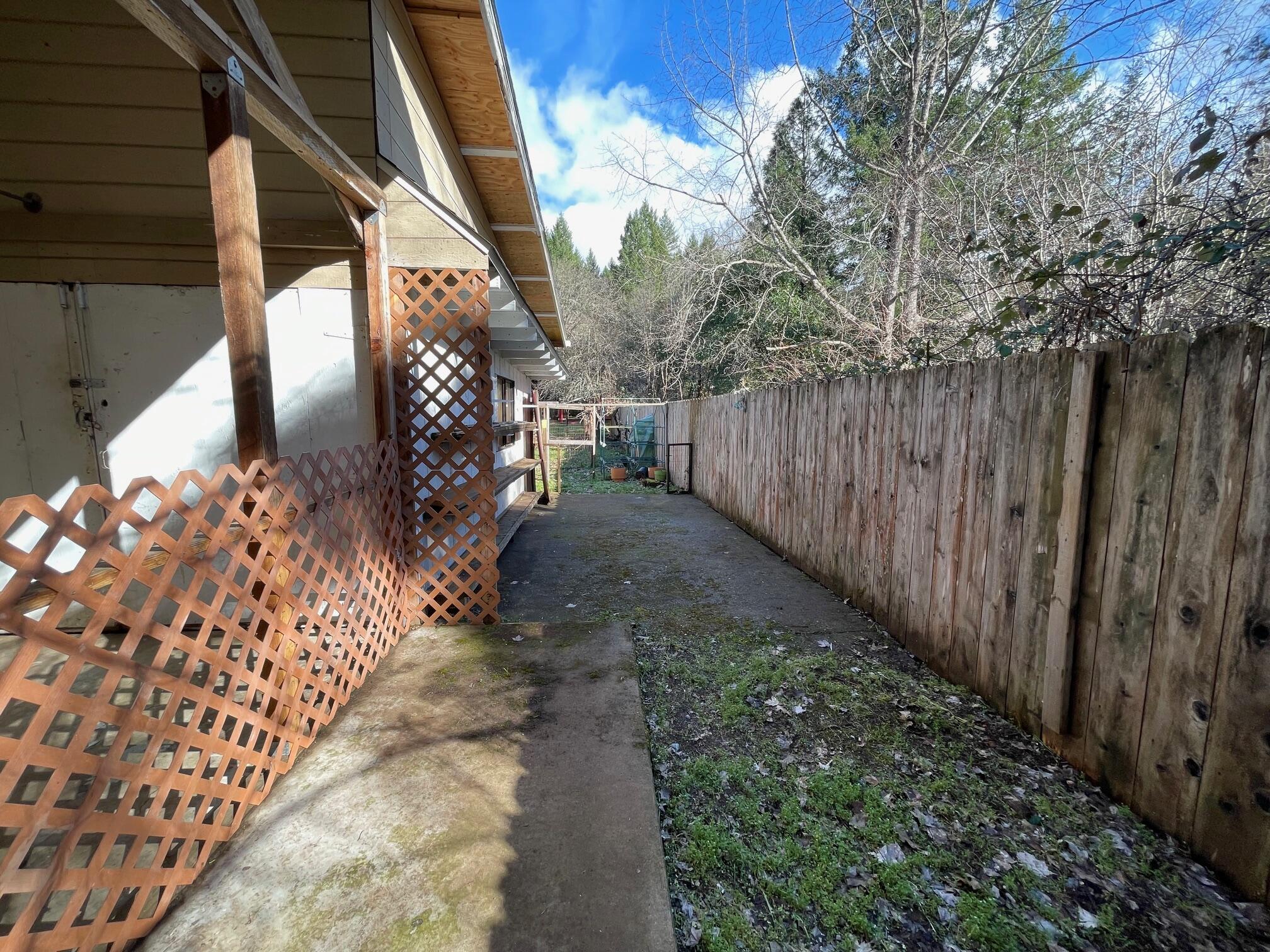 411 South Old Stage Road Cave Junction, OR 97523 - Photo 21 of 39 a view of path along with wooden fence