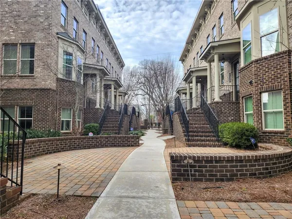 a view of a brick house with many windows
