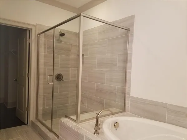 a bathroom with a shower and a sink